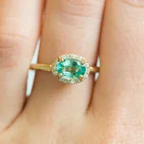 Neon Emerald East-West Oval Halo Ring in Evergreen Carved Yellow Gold